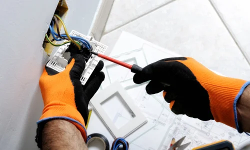 Electrician wiring a plug socket